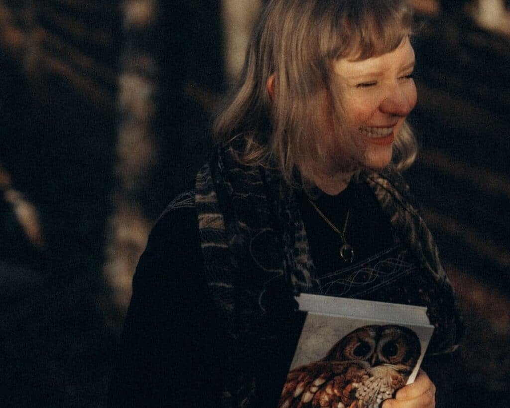 woman laughing with a book